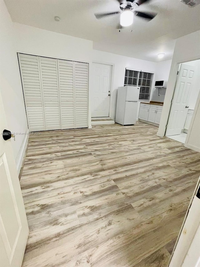 interior space featuring light hardwood / wood-style floors and ceiling fan