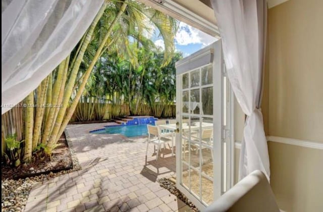 view of patio / terrace with a fenced in pool