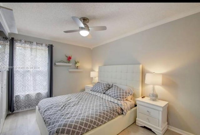 bedroom featuring multiple windows, a textured ceiling, ceiling fan, and crown molding