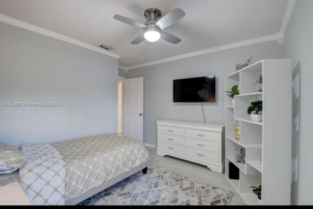 carpeted bedroom with ornamental molding and ceiling fan