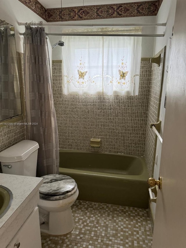 full bathroom featuring vanity, toilet, shower / bathtub combination with curtain, and tile patterned flooring