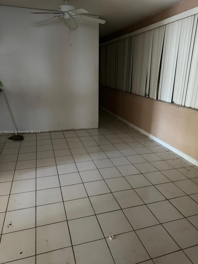 spare room featuring ceiling fan and light tile patterned floors