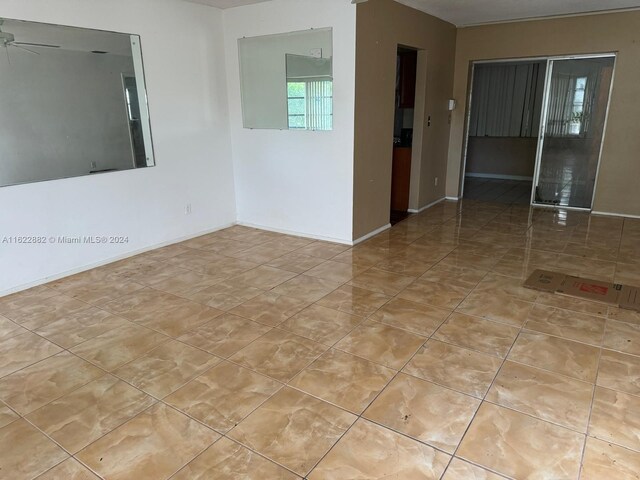 spare room with light tile patterned floors and ceiling fan