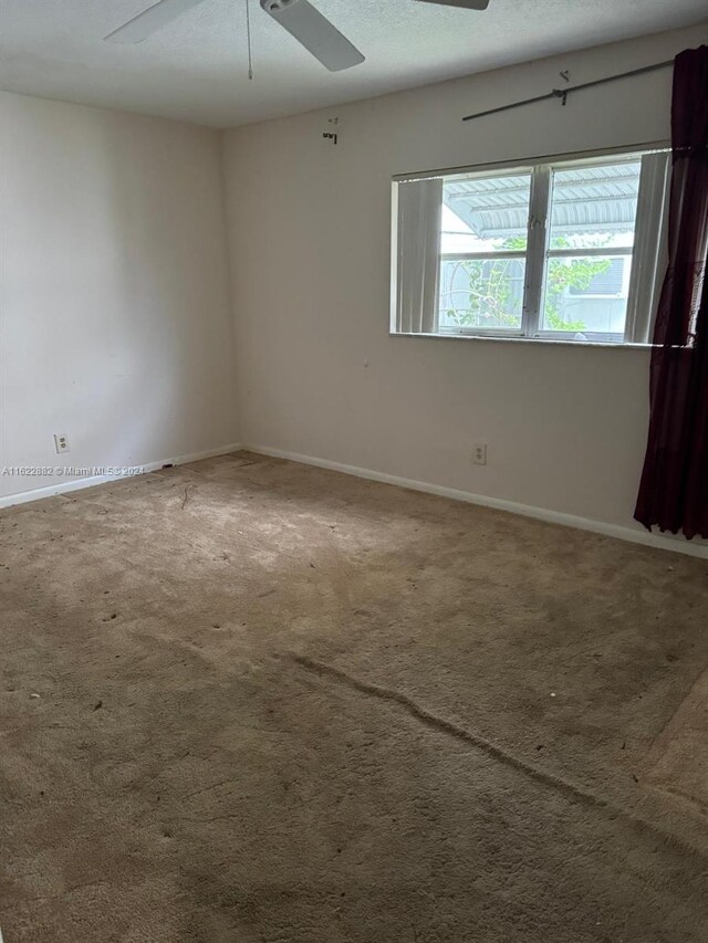 empty room with carpet floors and ceiling fan