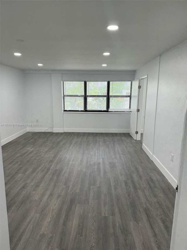 empty room featuring dark hardwood / wood-style flooring