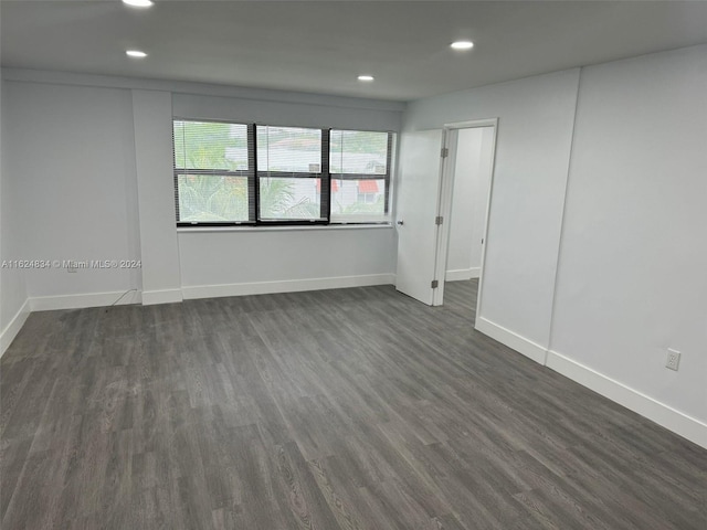 empty room with dark wood-type flooring