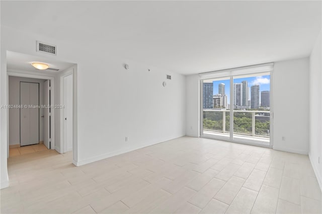 spare room featuring light tile patterned floors