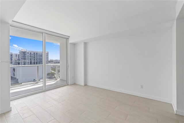 unfurnished room with expansive windows