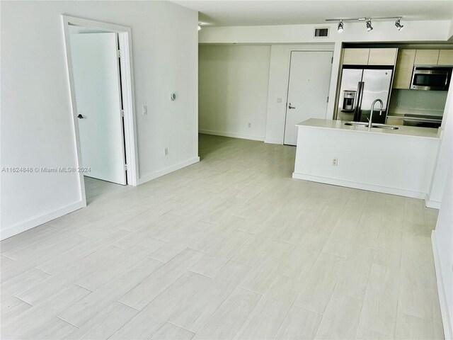4250 Biscayne Blvd Unit 1018, Miami, FL 33137 - kitchen with stainless steel appliances, light countertops, light wood-style floors, and a peninsula