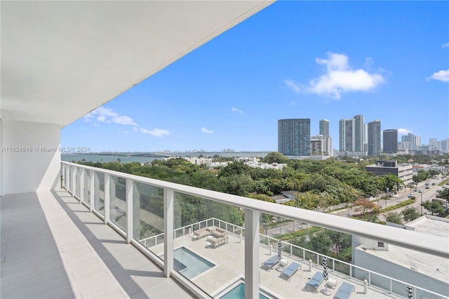 balcony featuring a fenced in pool