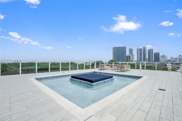 view of swimming pool with a jacuzzi and a patio area