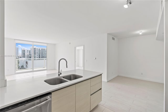 kitchen with light tile patterned flooring, dishwasher, and sink