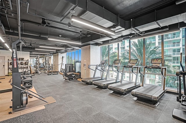 gym with a wall of windows