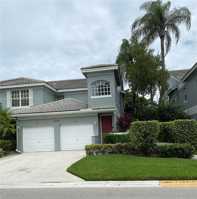 view of front property with a garage and a front yard