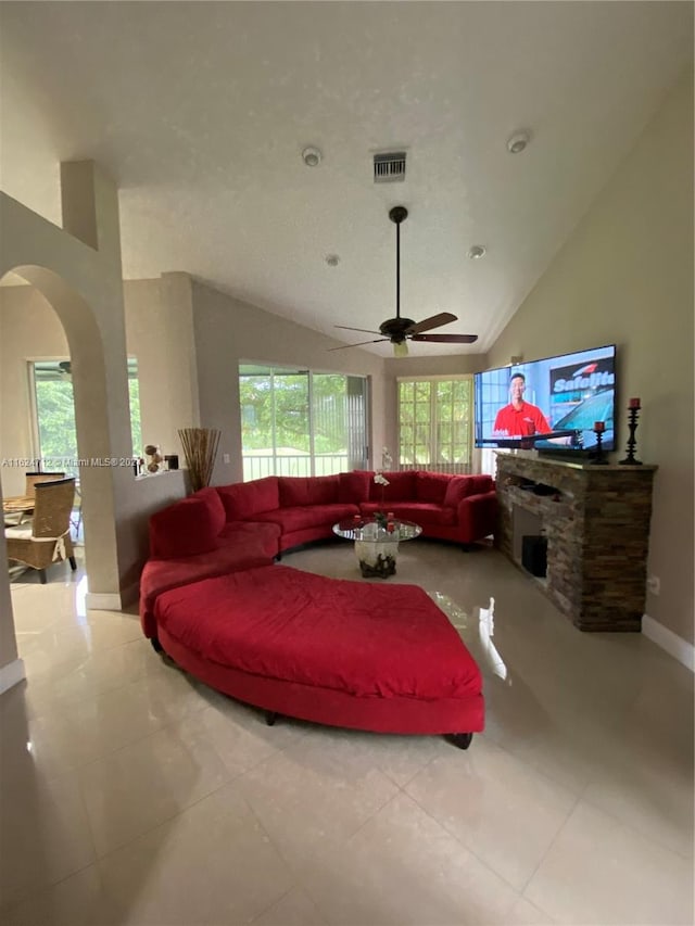 living room featuring a wealth of natural light, high vaulted ceiling, ceiling fan, and tile patterned floors