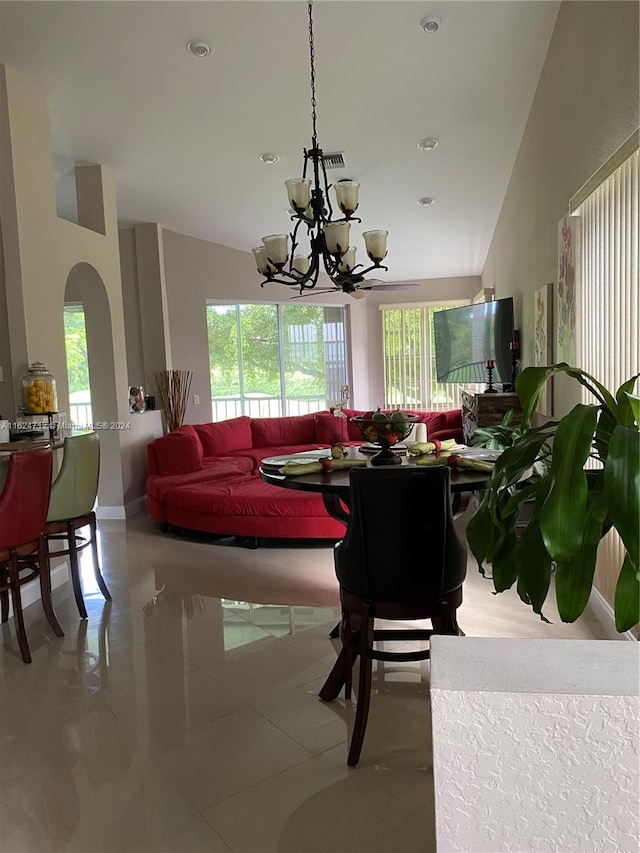 living room featuring tile patterned flooring, a notable chandelier, and high vaulted ceiling