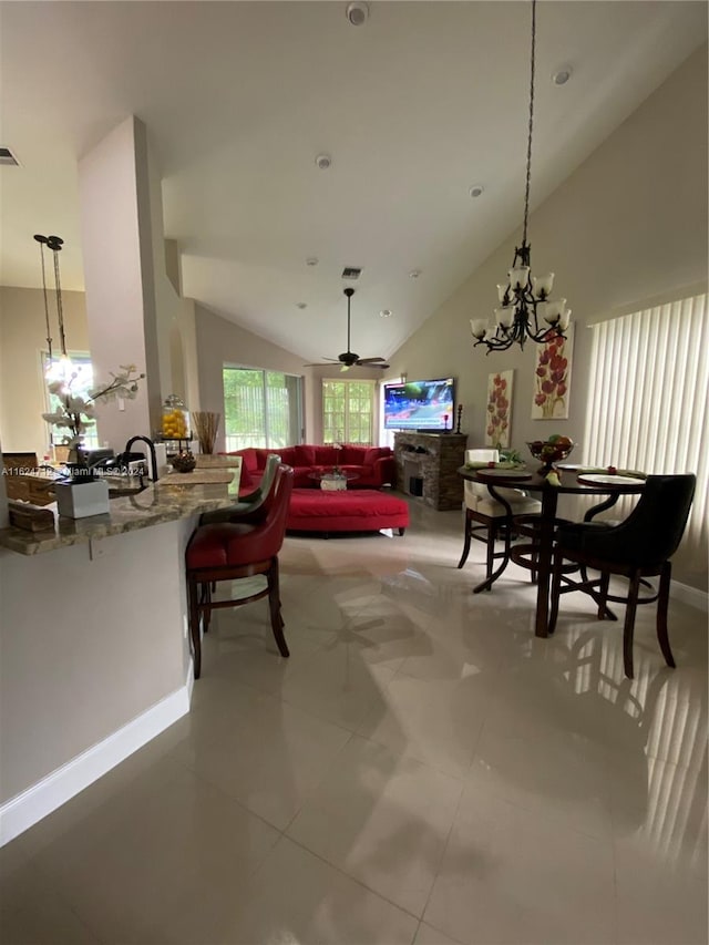 dining area featuring lofted ceiling, ceiling fan, and tile patterned floors