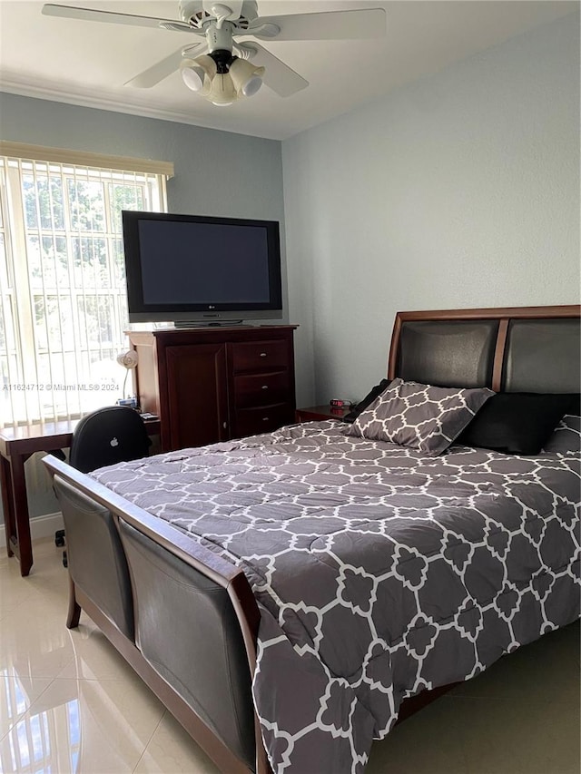 tiled bedroom featuring ceiling fan