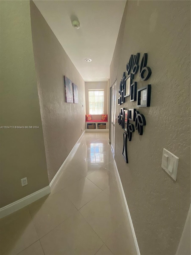 hallway featuring tile patterned flooring