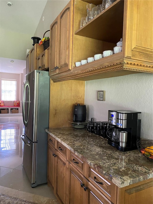 kitchen featuring tile patterned flooring and stainless steel fridge