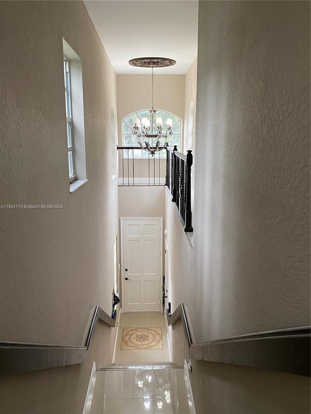 interior space featuring a chandelier and tile patterned floors