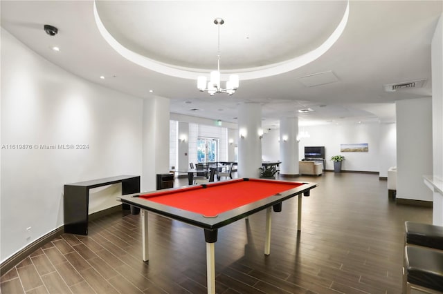 playroom with dark hardwood / wood-style floors, a raised ceiling, billiards, and an inviting chandelier