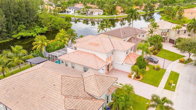 drone / aerial view with a residential view and a water view