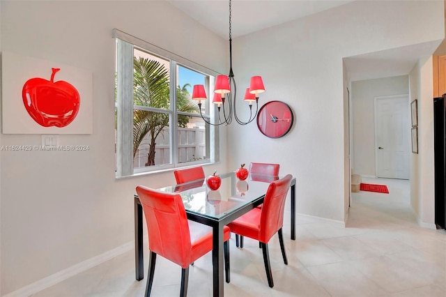 dining room with baseboards and a chandelier