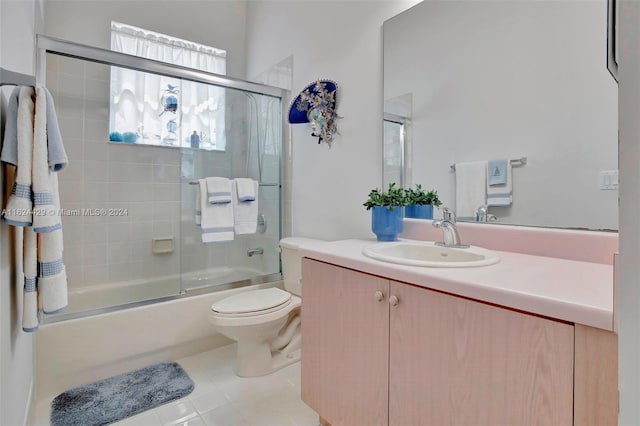 full bathroom featuring shower / bath combination with glass door, toilet, vanity, and tile patterned flooring