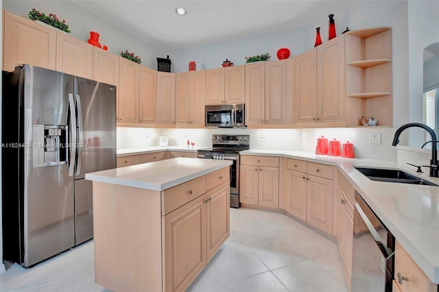 kitchen with a kitchen island, open shelves, a sink, light countertops, and appliances with stainless steel finishes