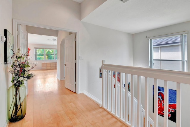 hallway with baseboards and light wood-style flooring