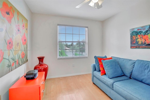 living room with a ceiling fan, wood finished floors, and baseboards