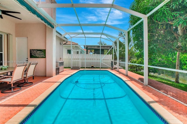 view of pool with a fenced in pool, fence, a lanai, and a patio area