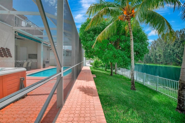 exterior space featuring a water view, a patio, a fenced backyard, a fenced in pool, and a lanai