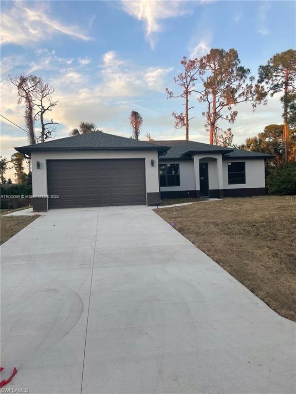 single story home featuring a garage