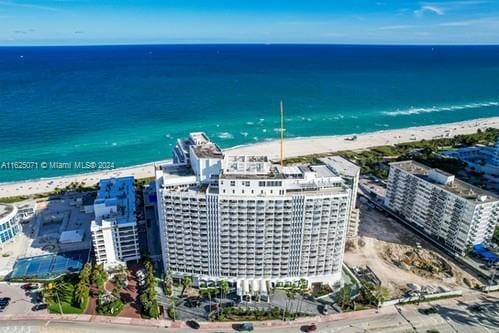 aerial view featuring a water view and a beach view