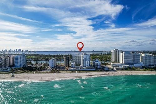 birds eye view of property with a view of the beach and a water view