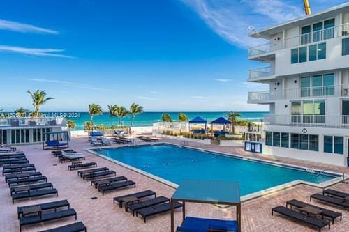 view of pool featuring a water view