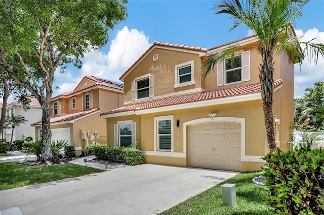 mediterranean / spanish-style house with a garage