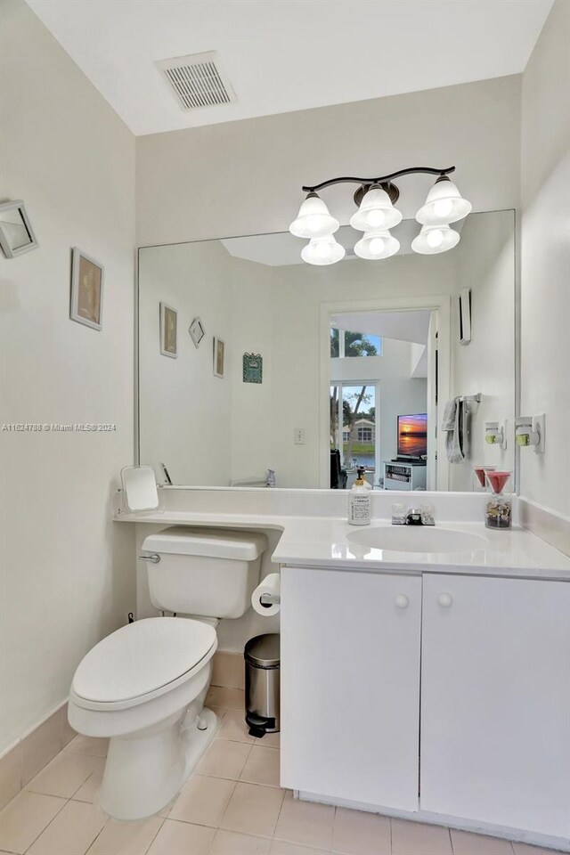 kitchen featuring a center island, white cabinetry, stainless steel appliances, and light tile patterned floors