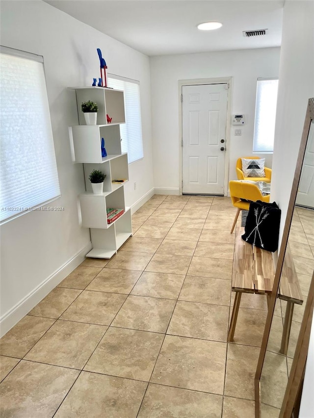 interior space featuring light tile patterned floors and plenty of natural light