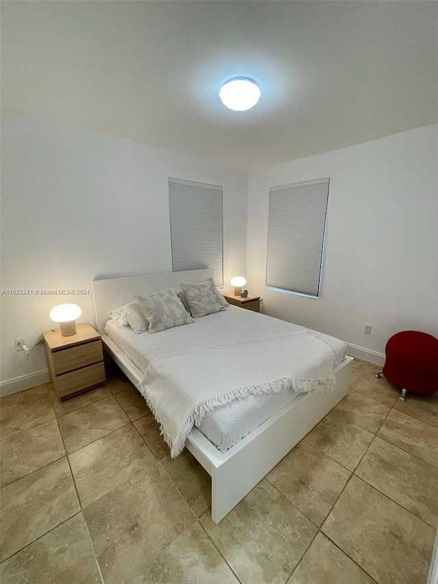 bedroom with light tile patterned floors