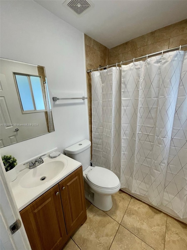 bathroom featuring tile patterned floors, vanity, and toilet