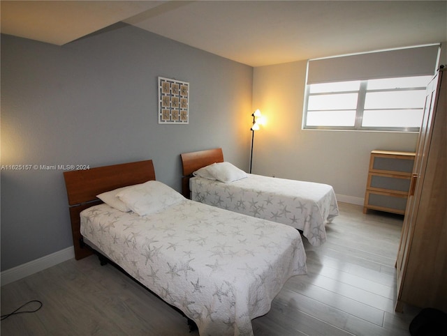 bedroom with hardwood / wood-style floors