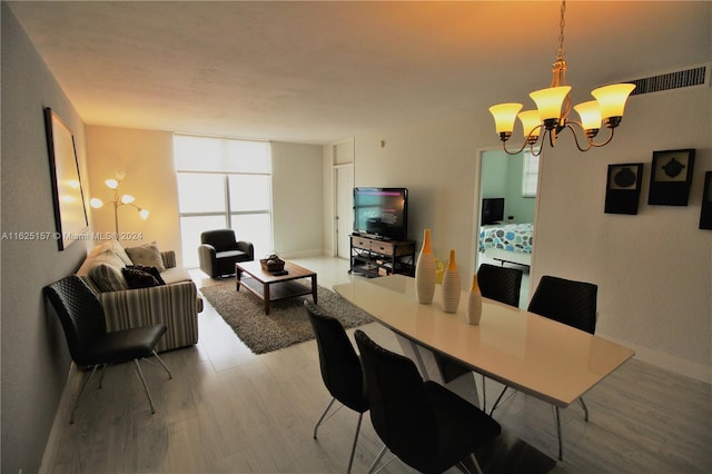 dining room featuring an inviting chandelier and hardwood / wood-style flooring