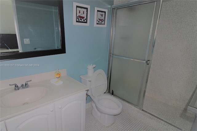 bathroom featuring walk in shower, tile patterned floors, toilet, and vanity