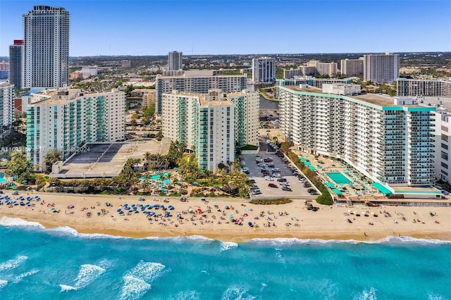 bird's eye view featuring a water view and a beach view