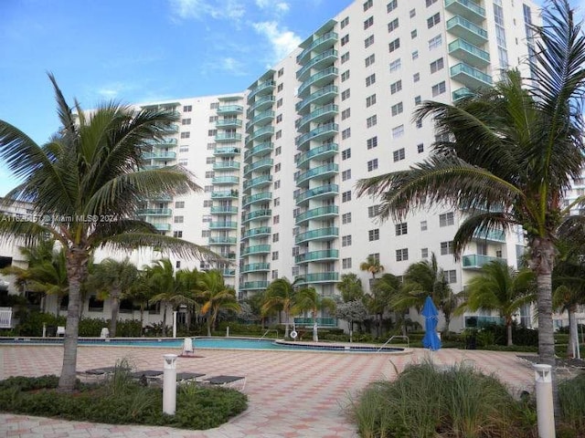 view of building exterior with a community pool