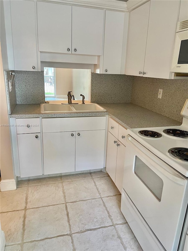 kitchen featuring decorative backsplash, sink, white cabinets, and white appliances