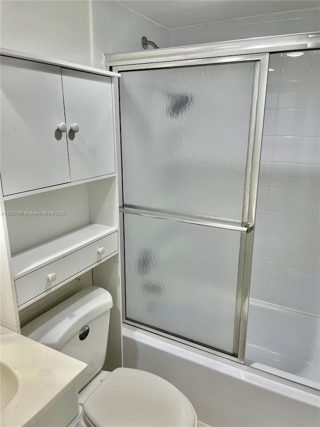 full bathroom with vanity, toilet, and shower / bath combination with glass door